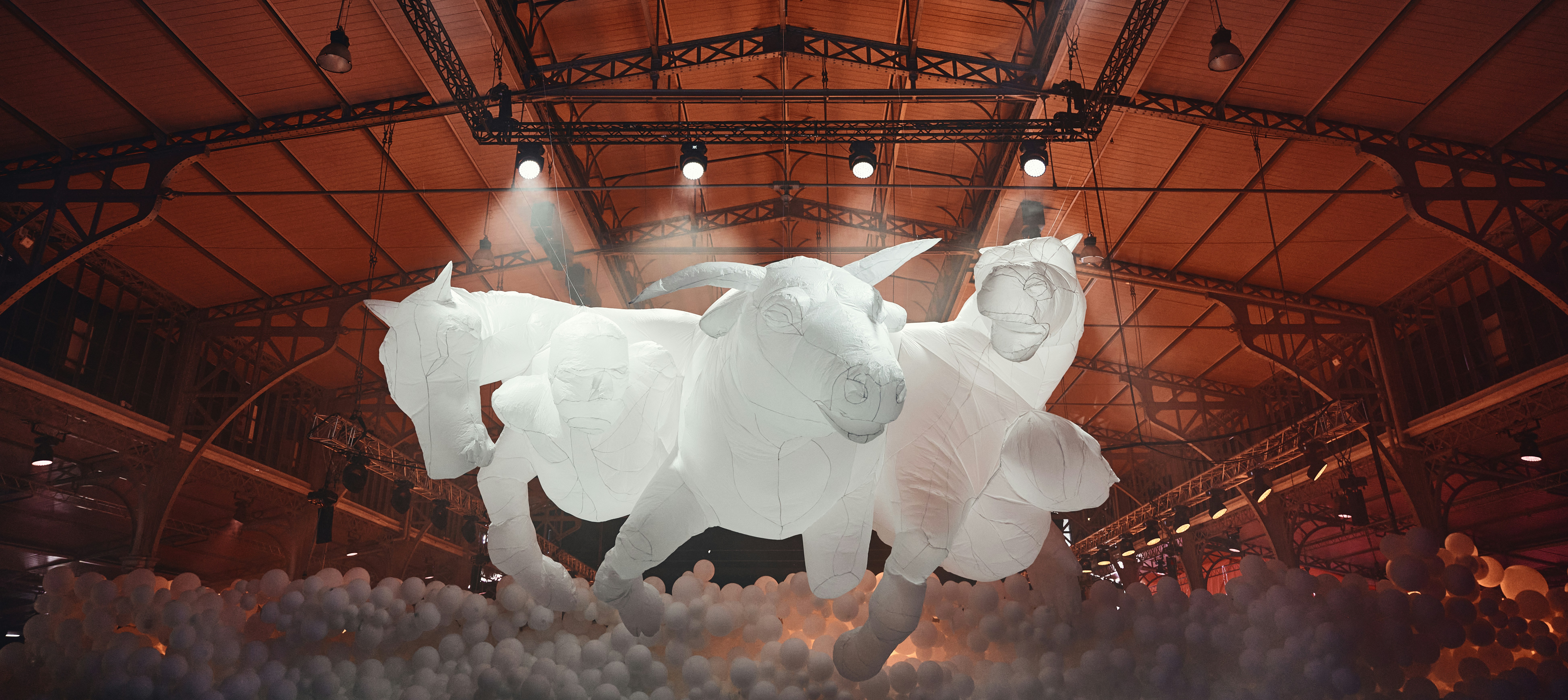 a couple of white statues in a room with lights