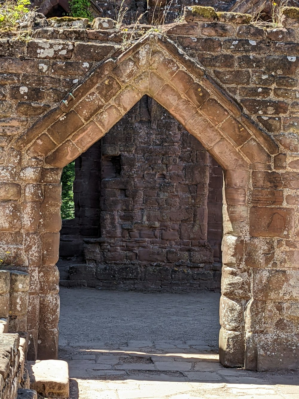 a stone archway with a walkway
