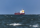 a large red and white ship in the ocean