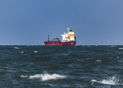 a large red and white ship in the ocean