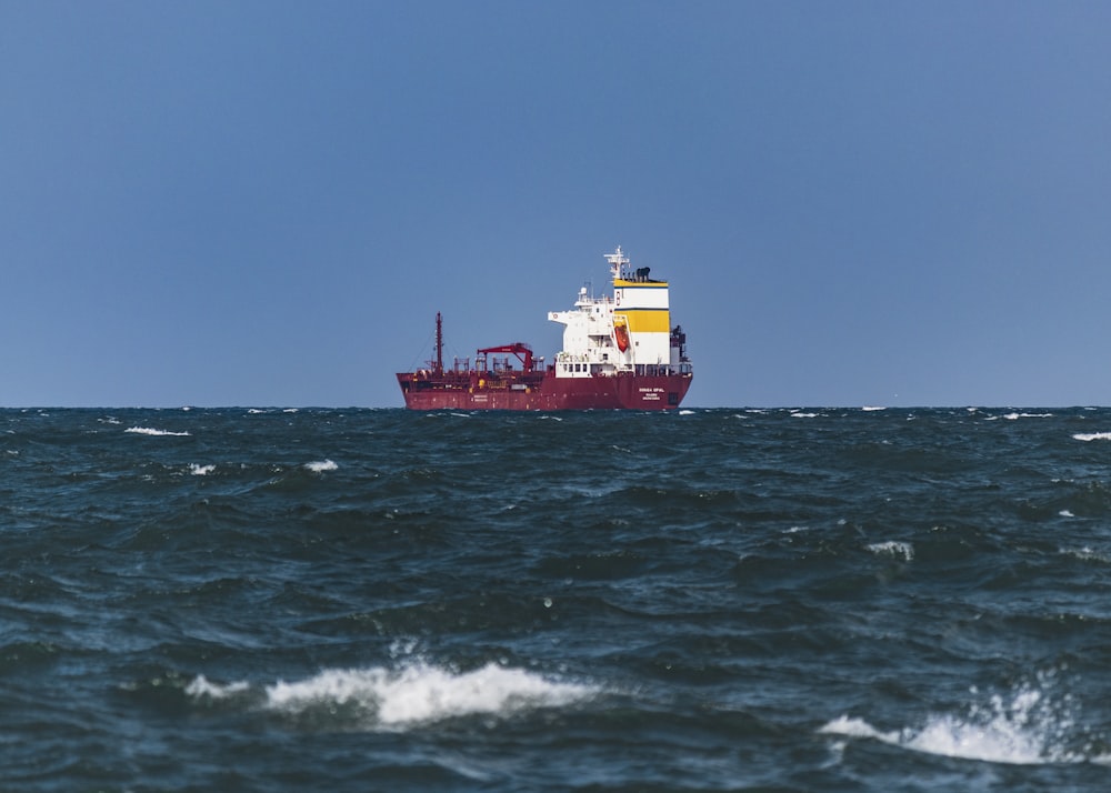 a large red and white ship in the ocean