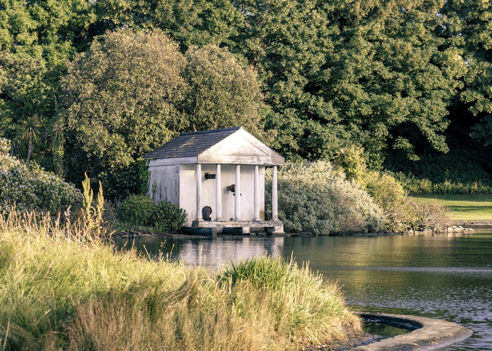 a white building on a dock over a body of water