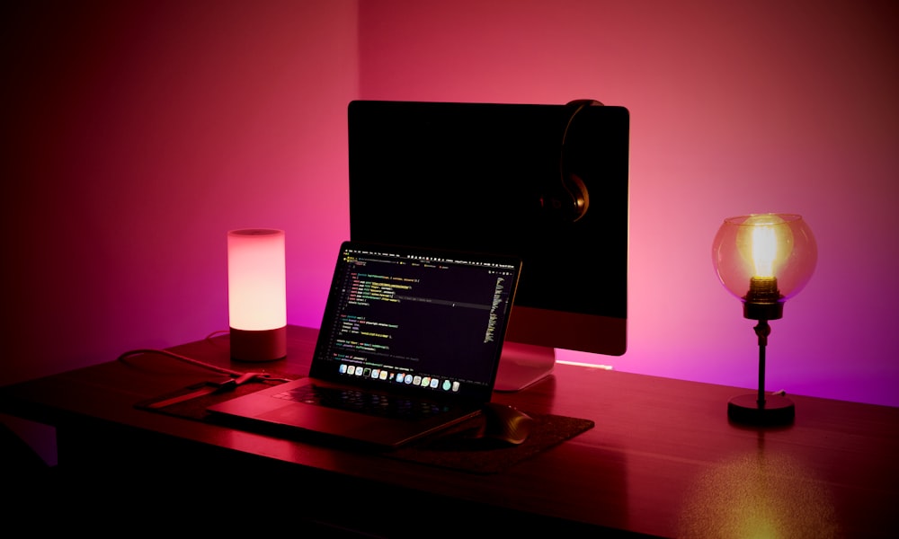 a laptop and a candle on a table