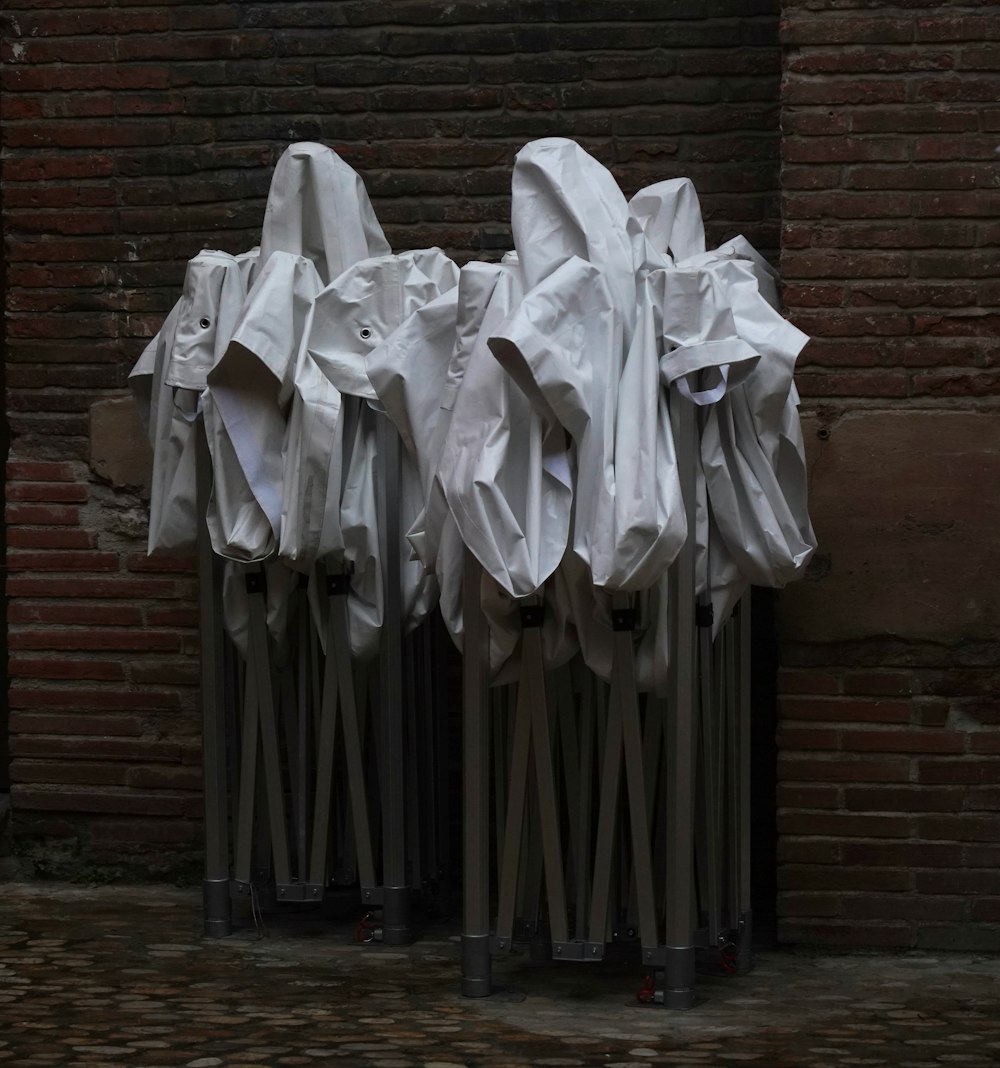 a group of white dresses on a wall