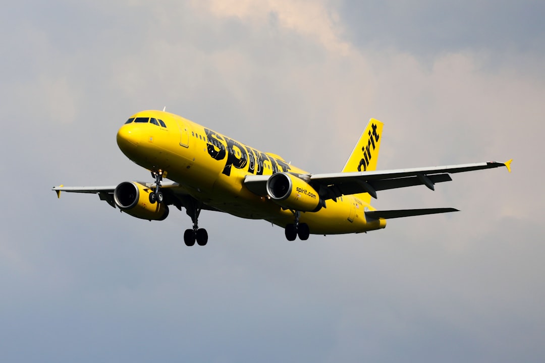 a yellow and black airplane flying, Spirit Airlines Airbus A320-200 (N608NK)