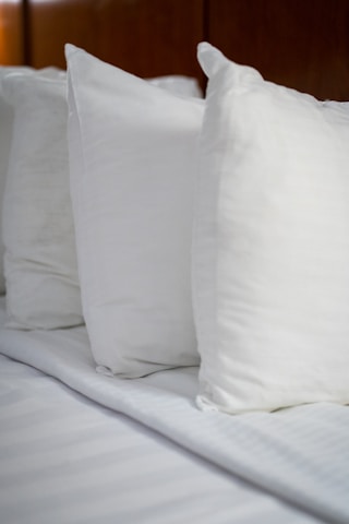 a white pillow on a bed