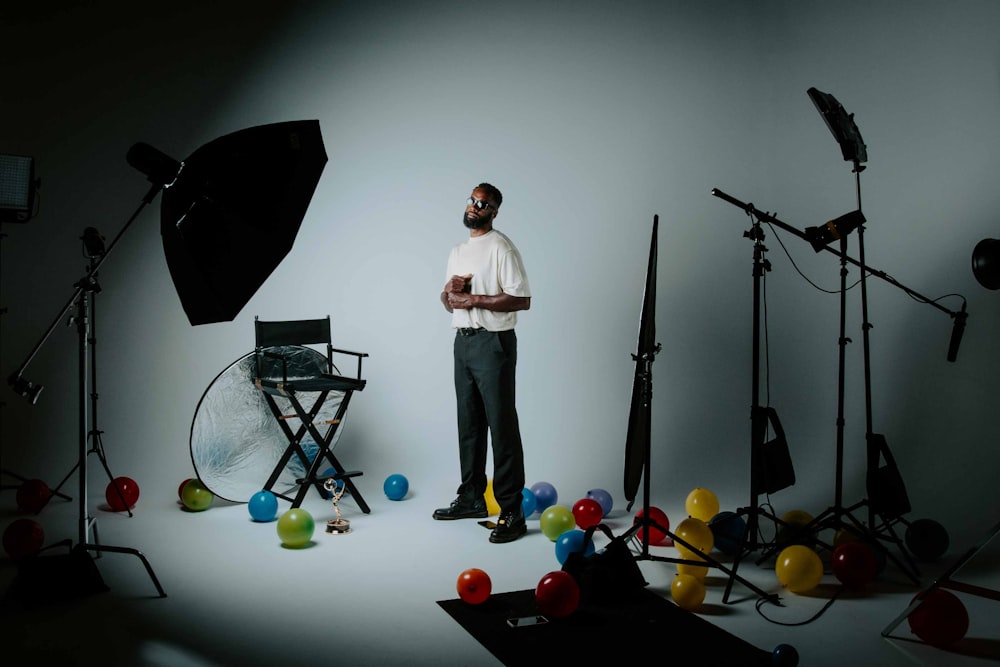 a person standing on a stage with a microphone and a group of objects