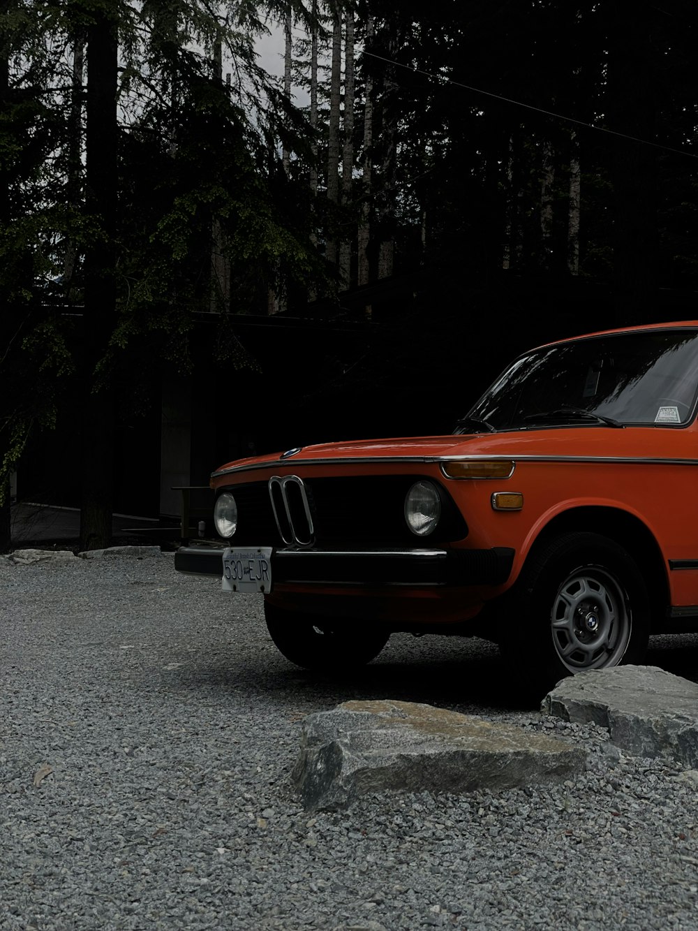 an orange car parked on a road