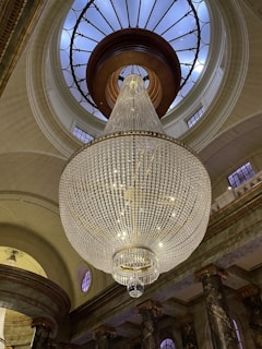 Our team carefully cleaning an elegant chandelier in a grand residence