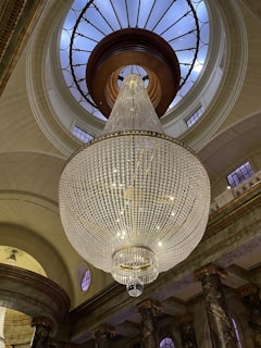 Our team carefully cleaning an elegant chandelier in a grand residence