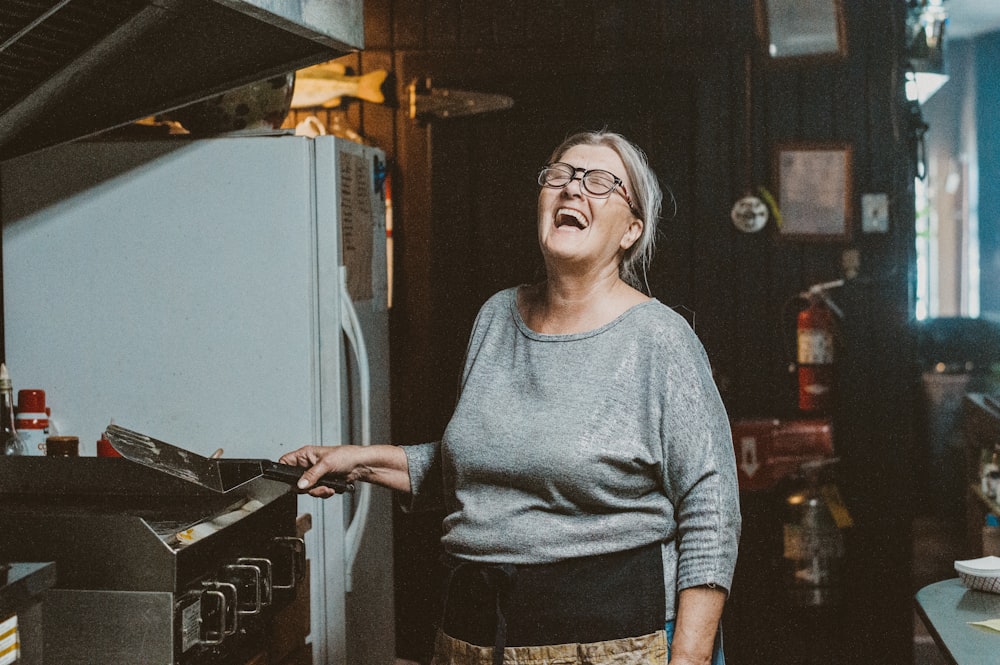 a person opening a refrigerator