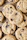 Close-up of golden chocolate chip cookies cooling on a wire rack with a glass of milk nearby.