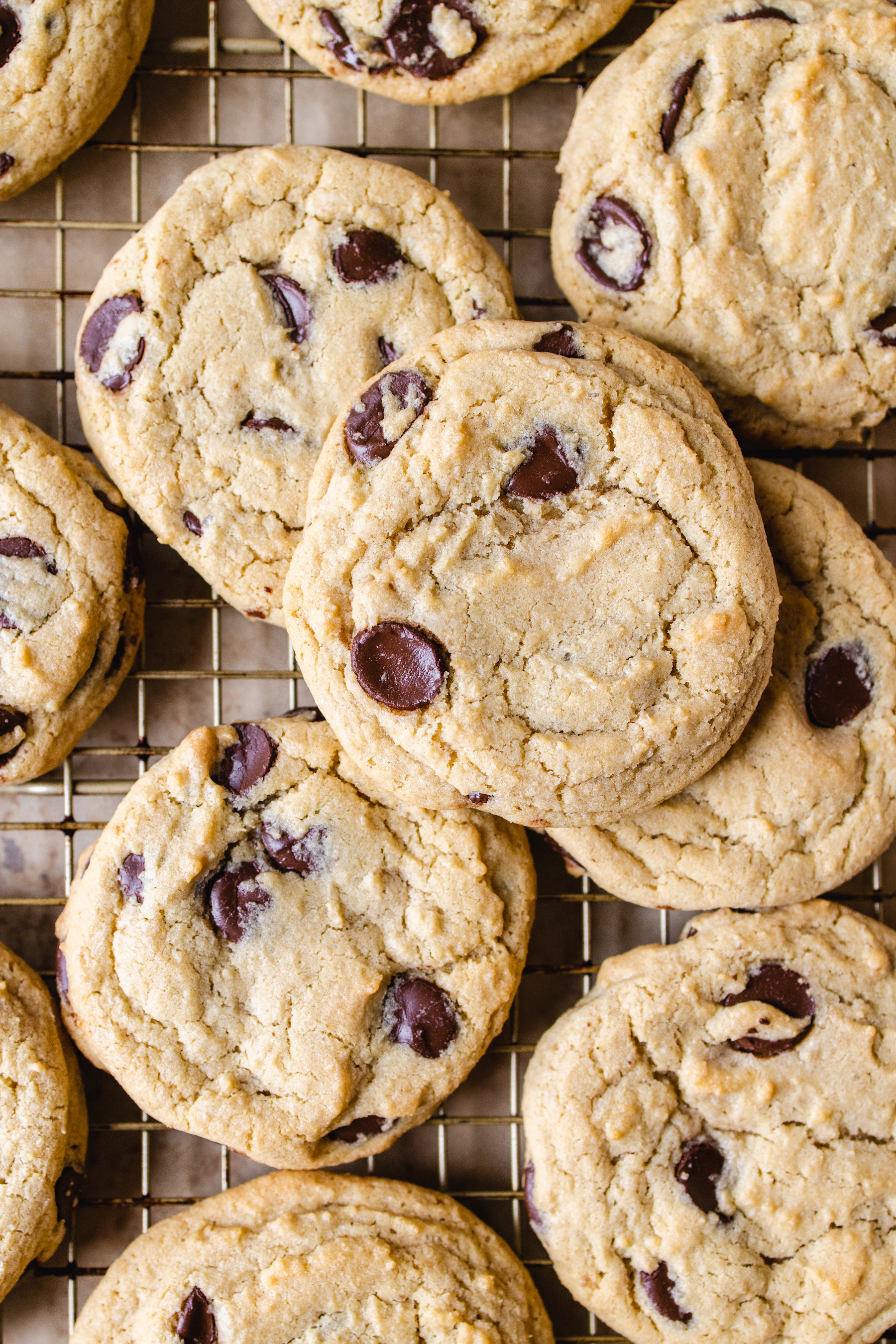 Chocolate chip cookies cooling on a wire rack, seen from above