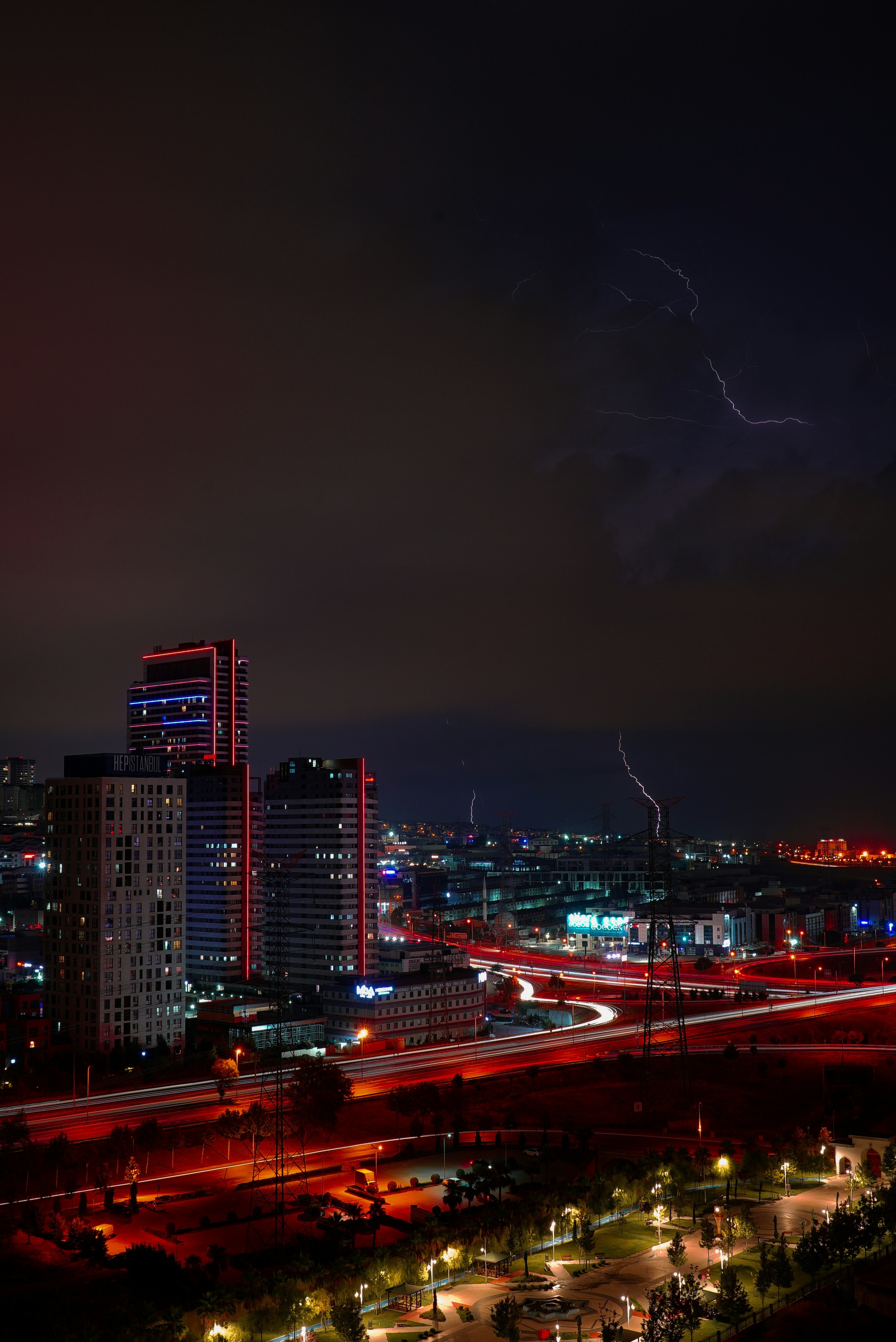 a city at night with lightning striking the ground