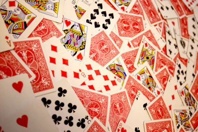 A vibrant spread of colorful magic playing cards arranged on a wooden table.