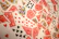 A vibrant assortment of playing cards scattered in a chaotic manner. The cards display various suits and numbers, predominantly featuring the colors red and black with intricate designs. Several face cards are visible, showcasing traditional royal characters in vivid detail.
