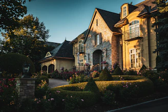a mansion with a garden in front of it