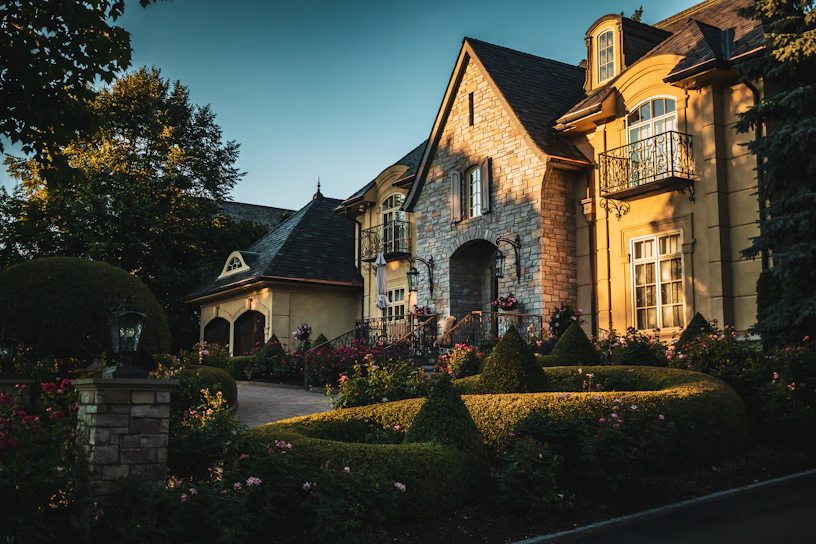 a mansion with a garden in front of it