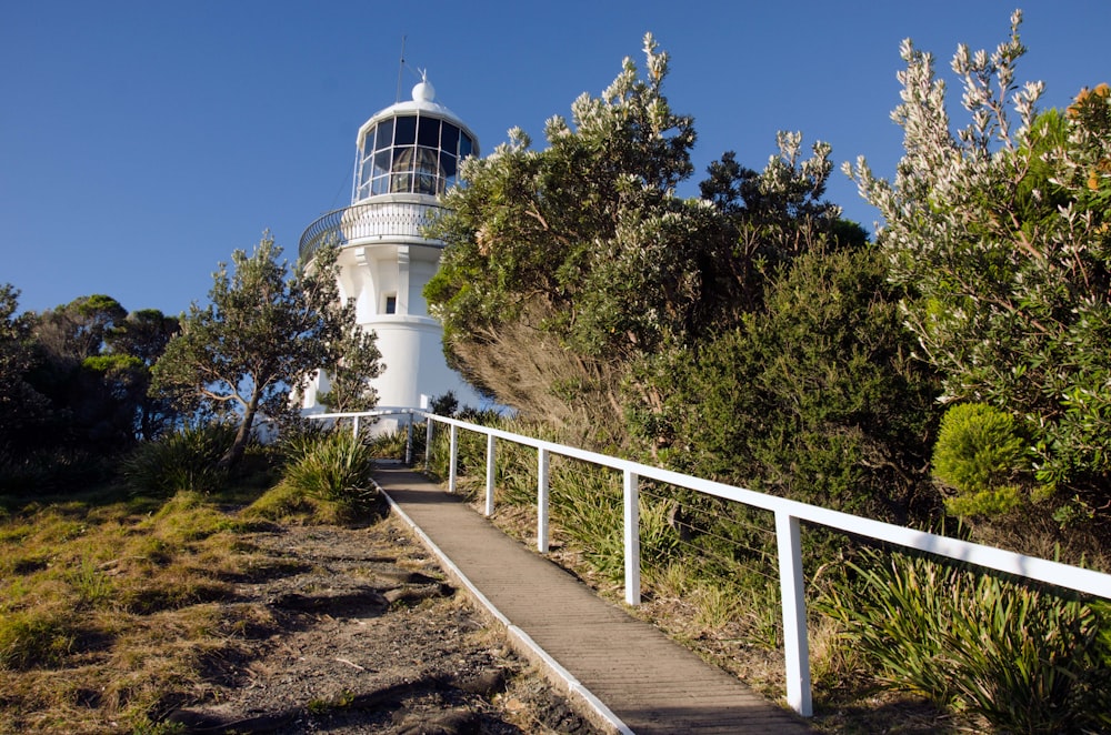 a white tower with a white fence