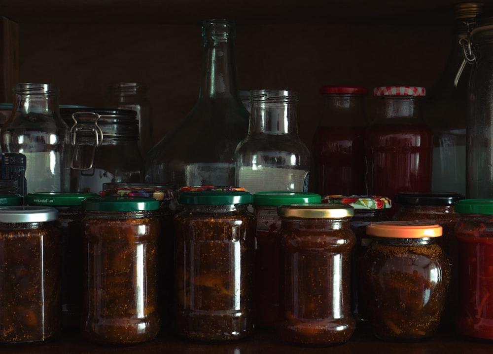 a group of glass jars with green liquid in them