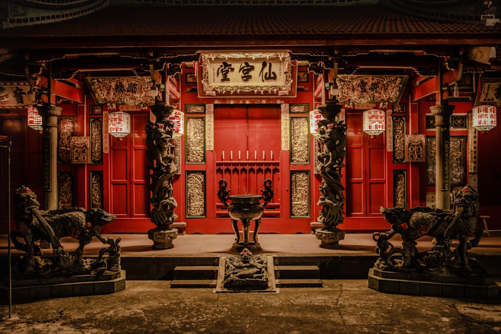 a building with statues and a red door