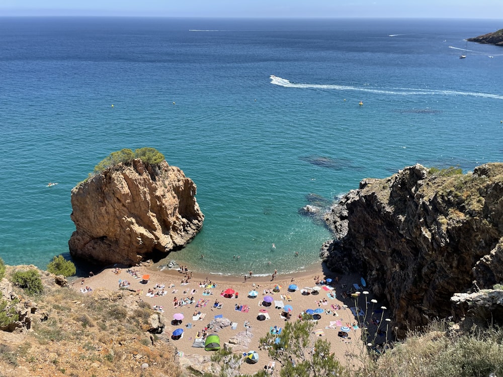 a beach with people and rocks