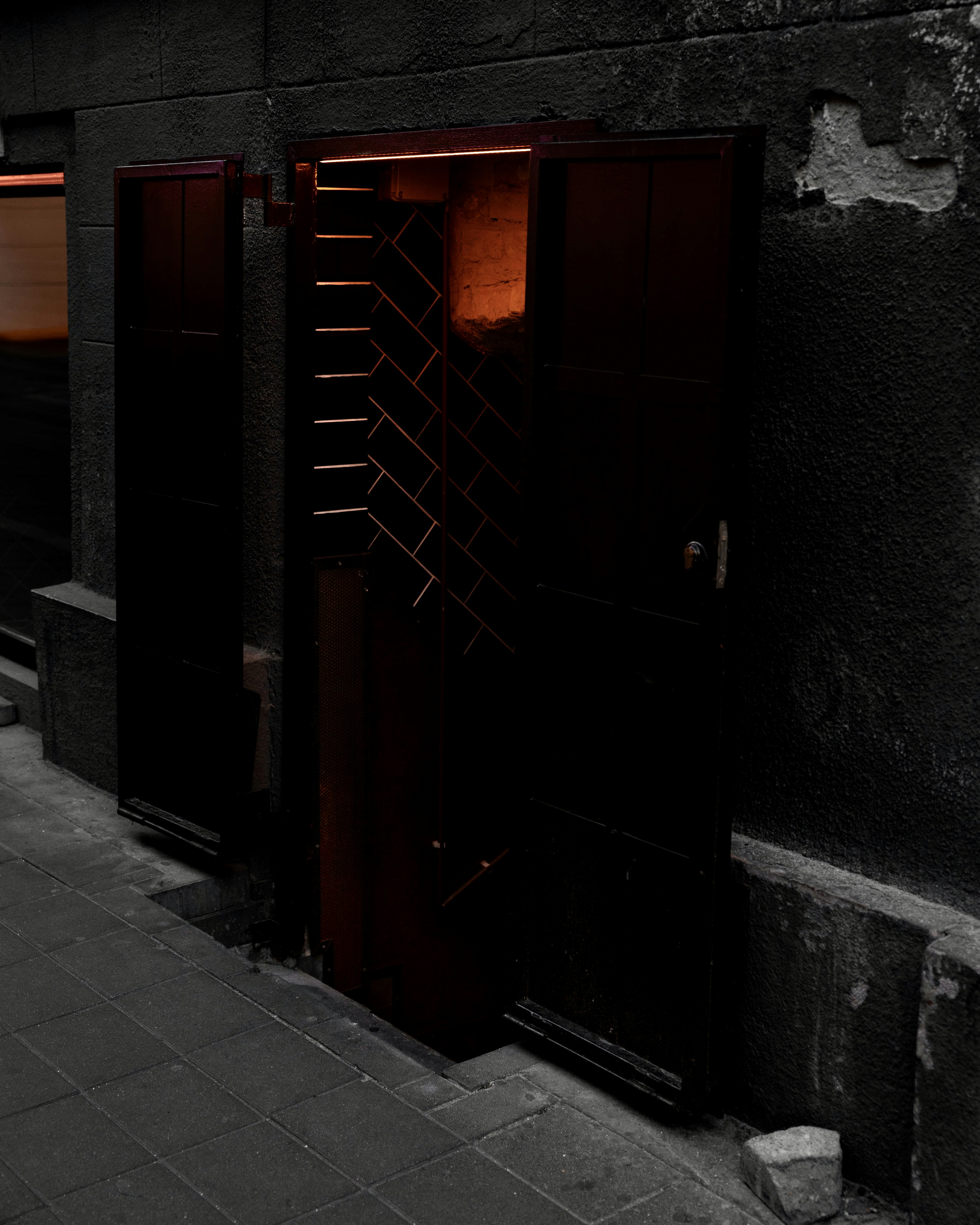 a black door in a stone building
