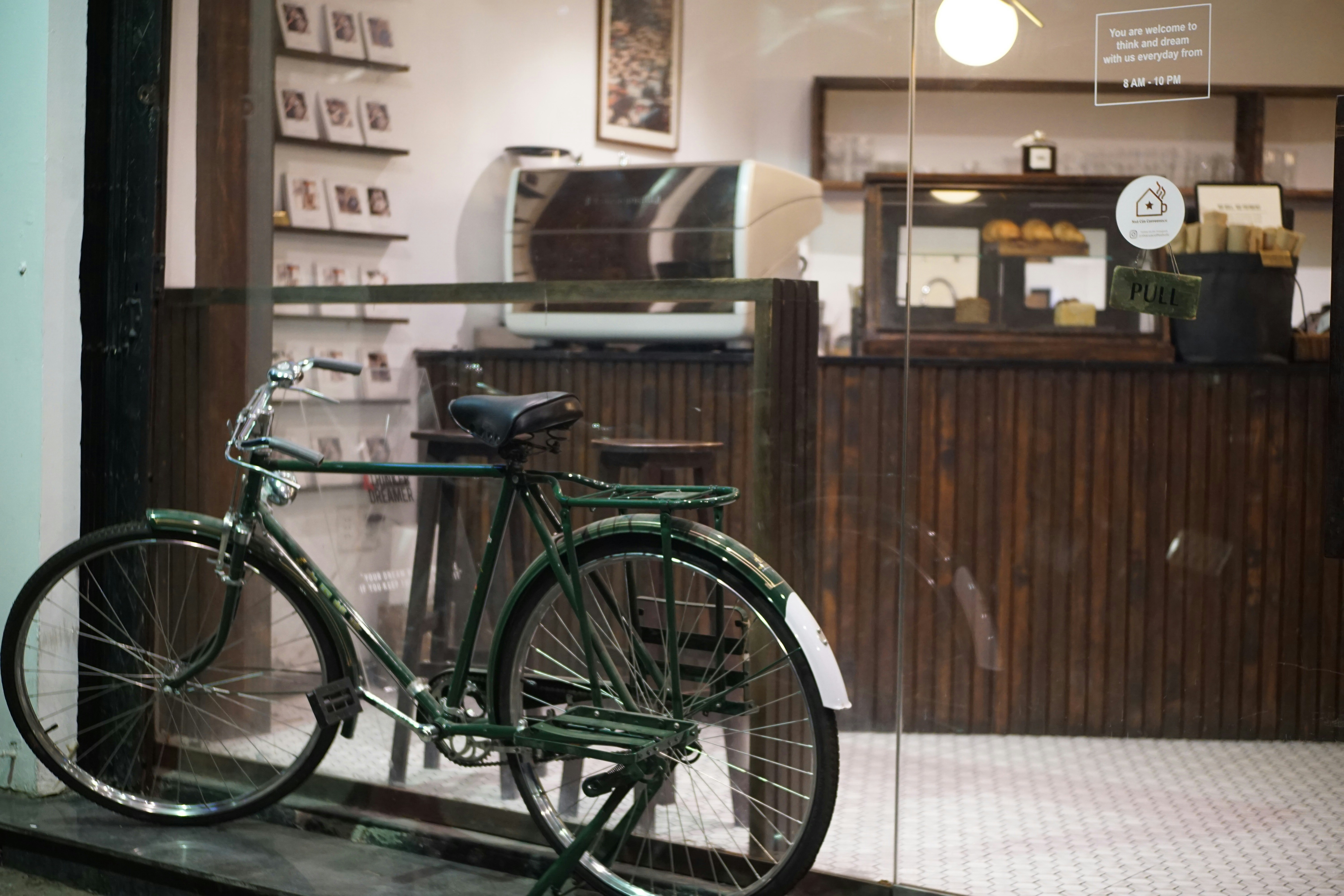 A bicycle parked in front of a store window