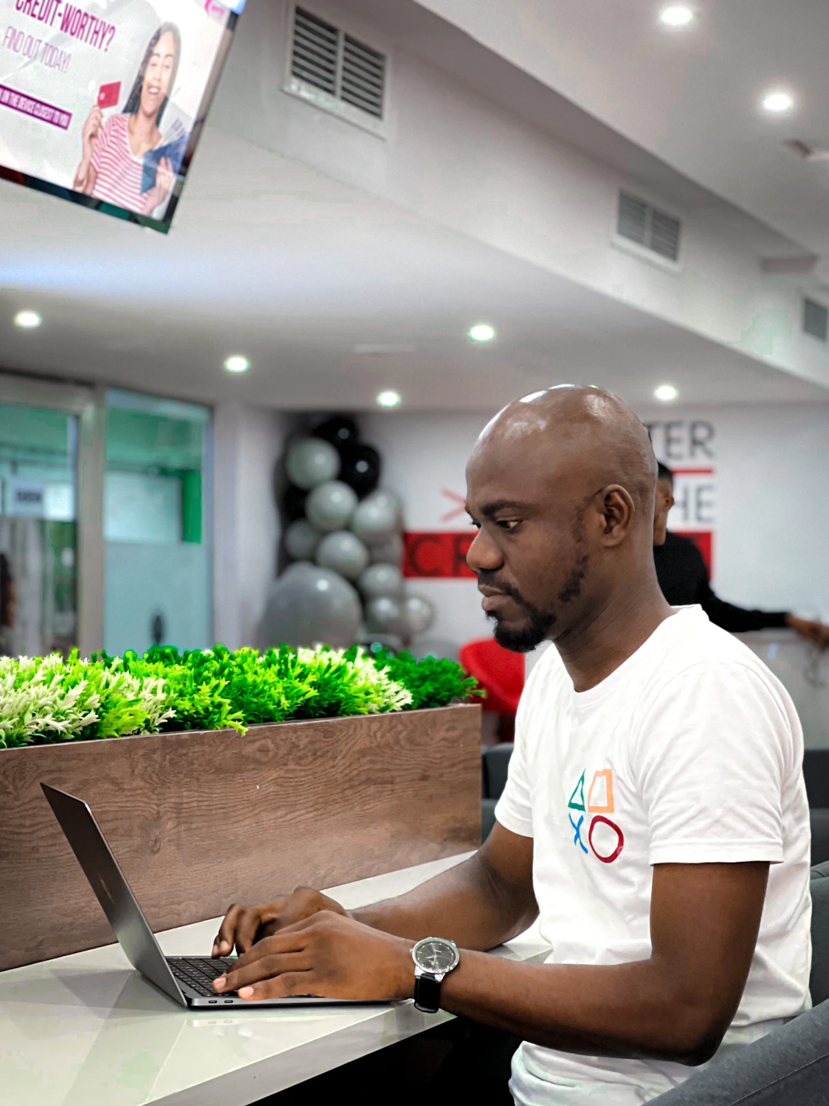 A man sitting at a table using a laptop