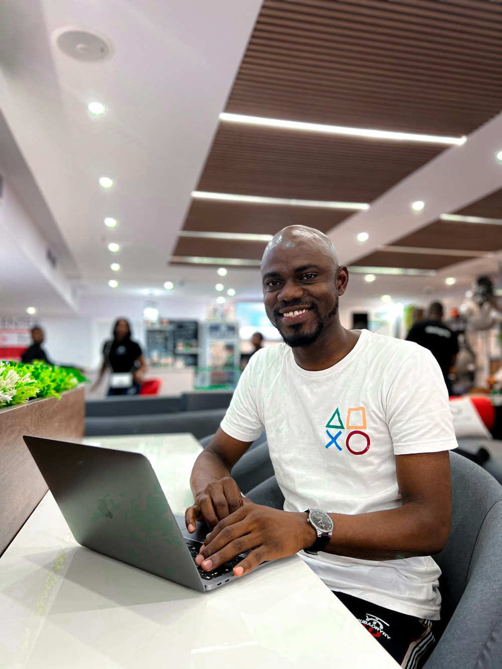 a man sitting at a table with a laptop