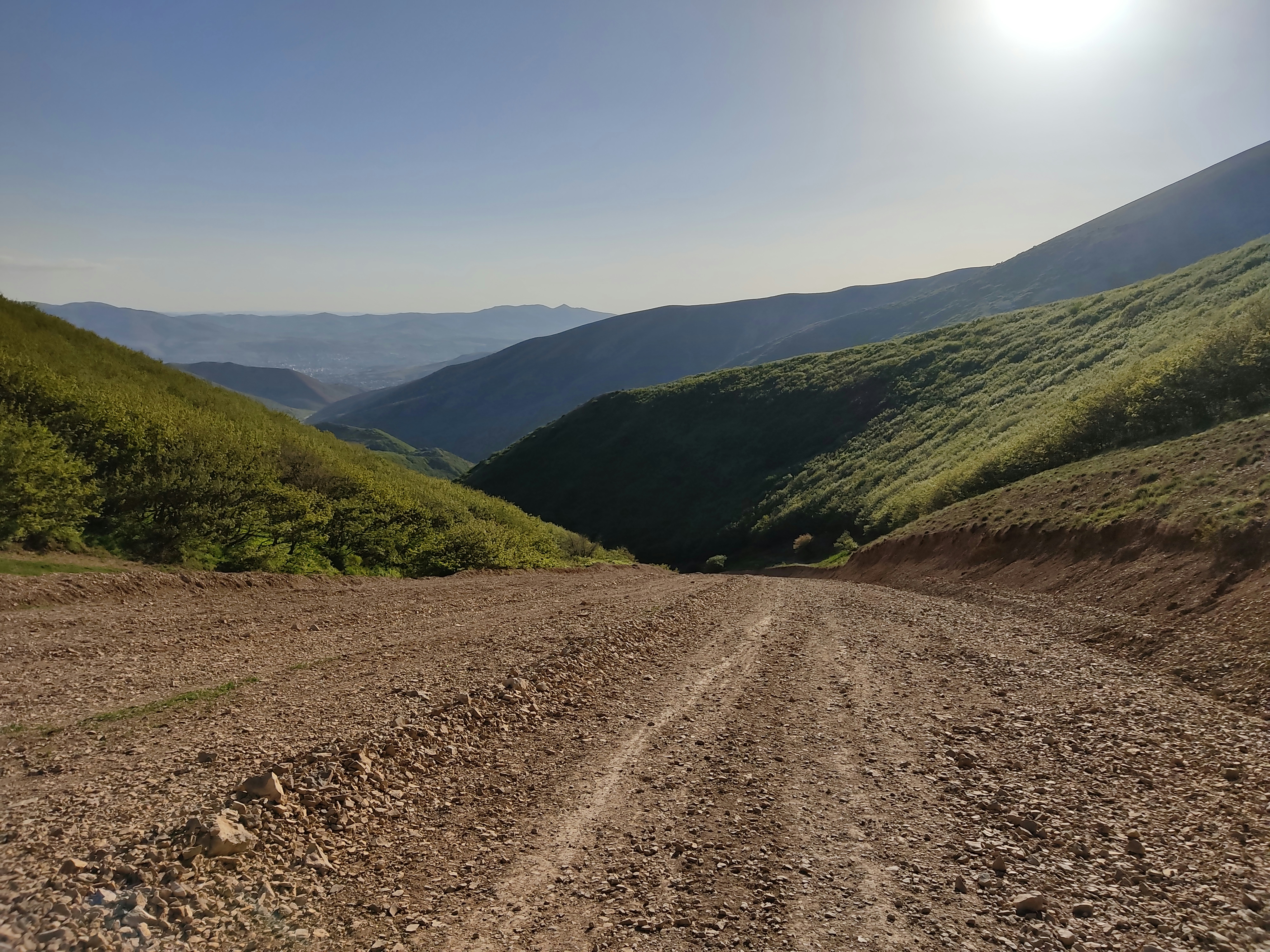 a dirt road in a valley