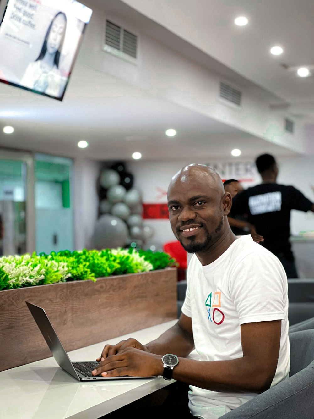 a man sitting at a table with a laptop