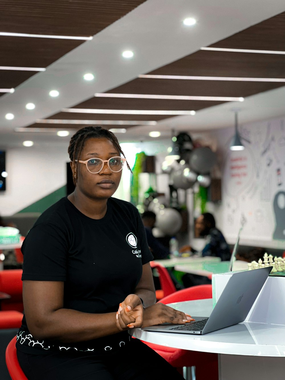 a person sitting at a table with a laptop