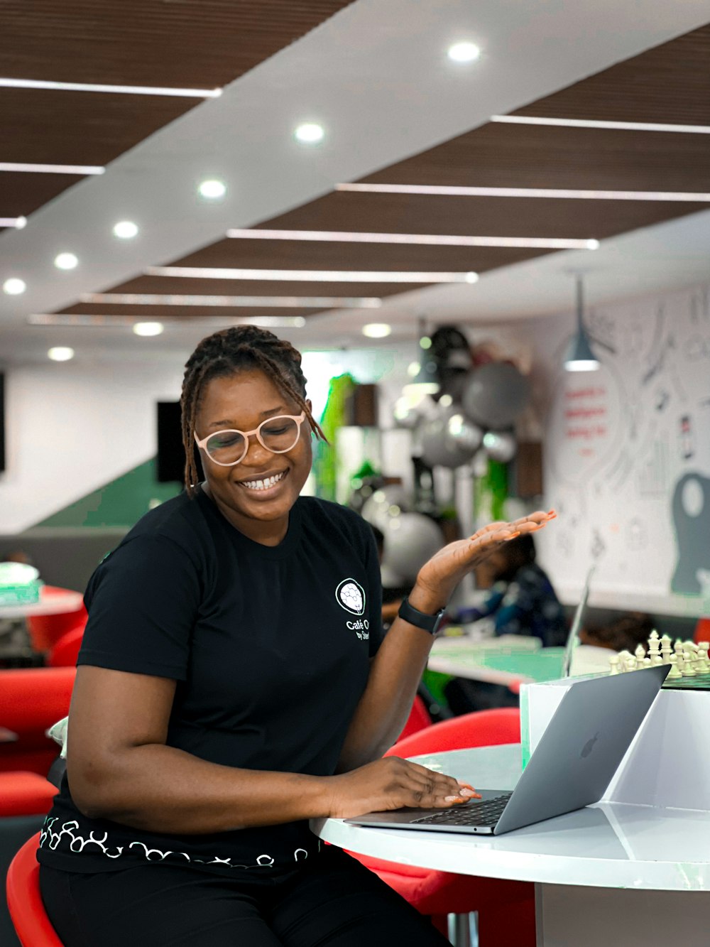 a person sitting at a table with a laptop