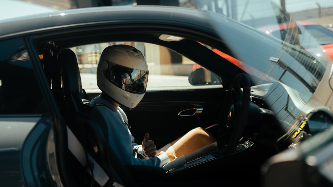 Driver with helmet in a car on a track day  - Castle Combe Race Circuit, North Wiltshire, UK – Photo by Marc Kleen | Castle Combe England