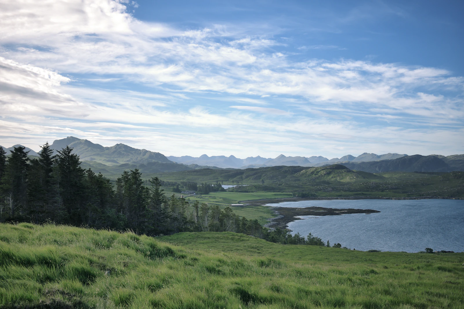 A lake surrounded by trees and mountains in the Scottish Highlands
