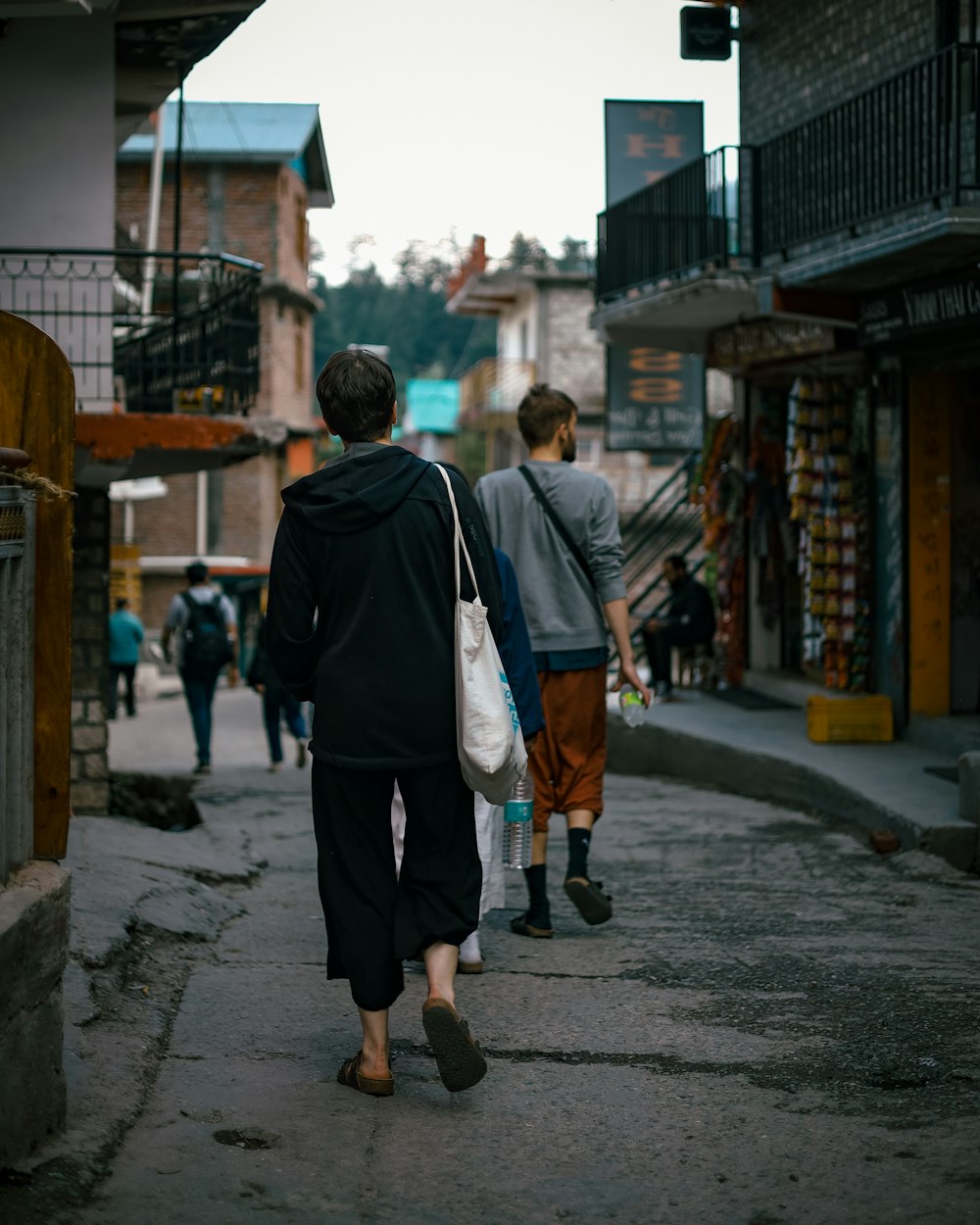 two people walking down a street