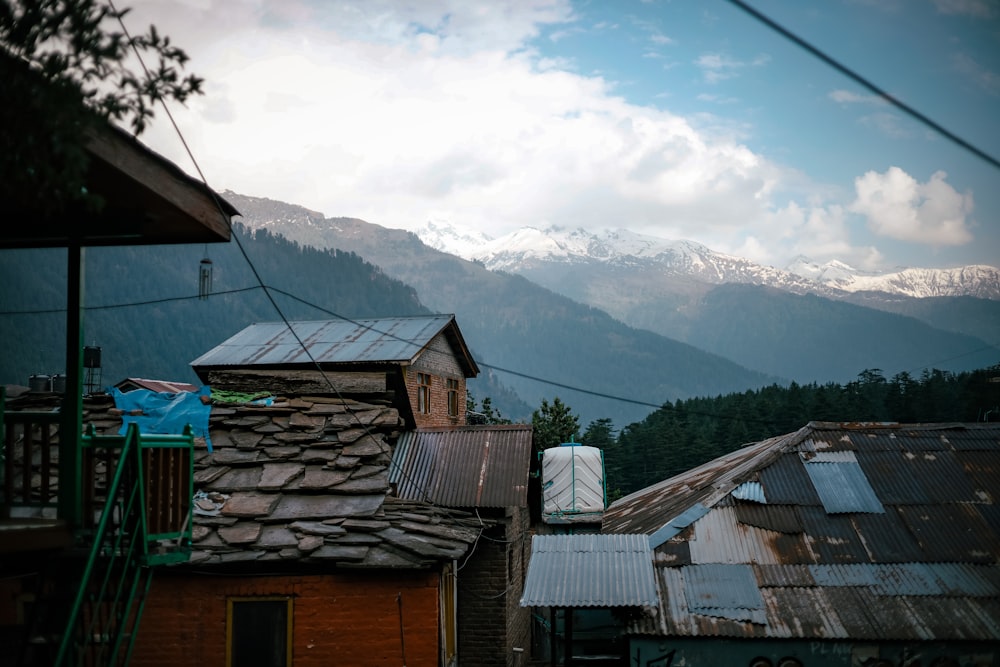 a group of houses with mountains in the background