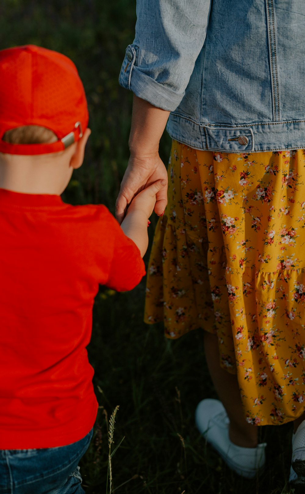 a person holding a child's hand