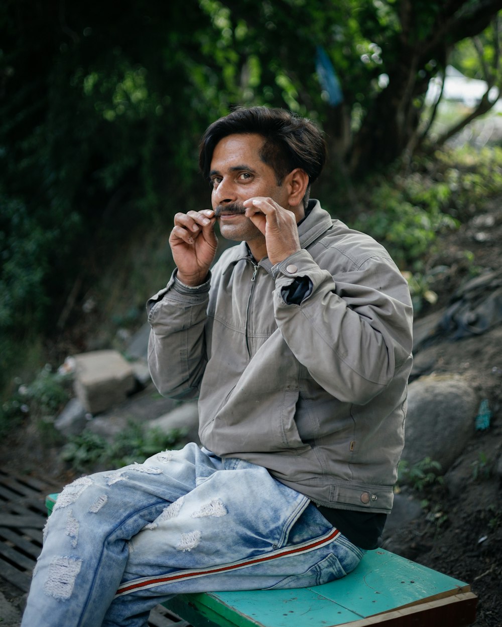 a person sitting on a bench smoking a cigarette