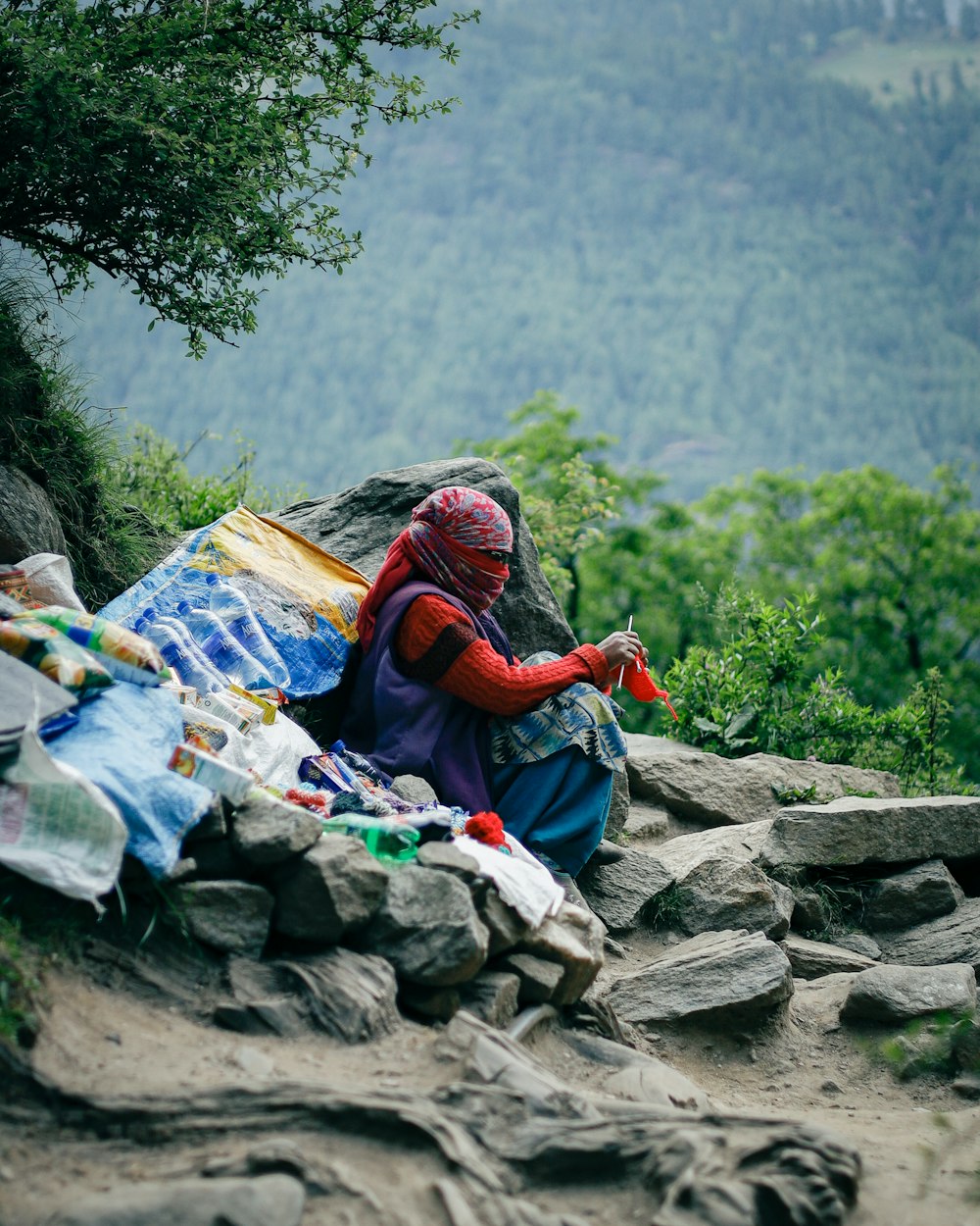 a person sitting on a rock