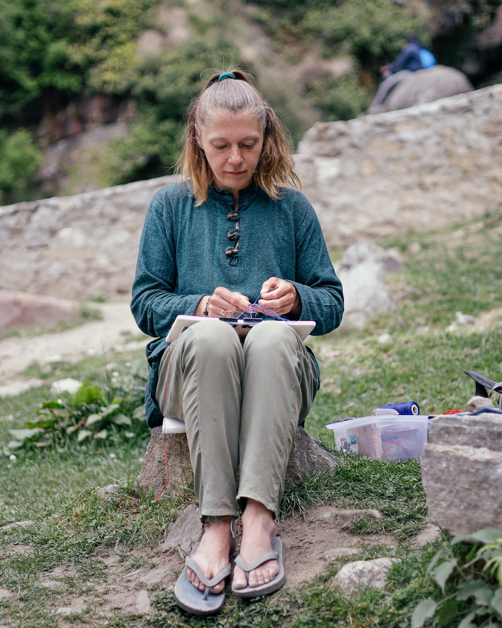 a person sitting on a rock