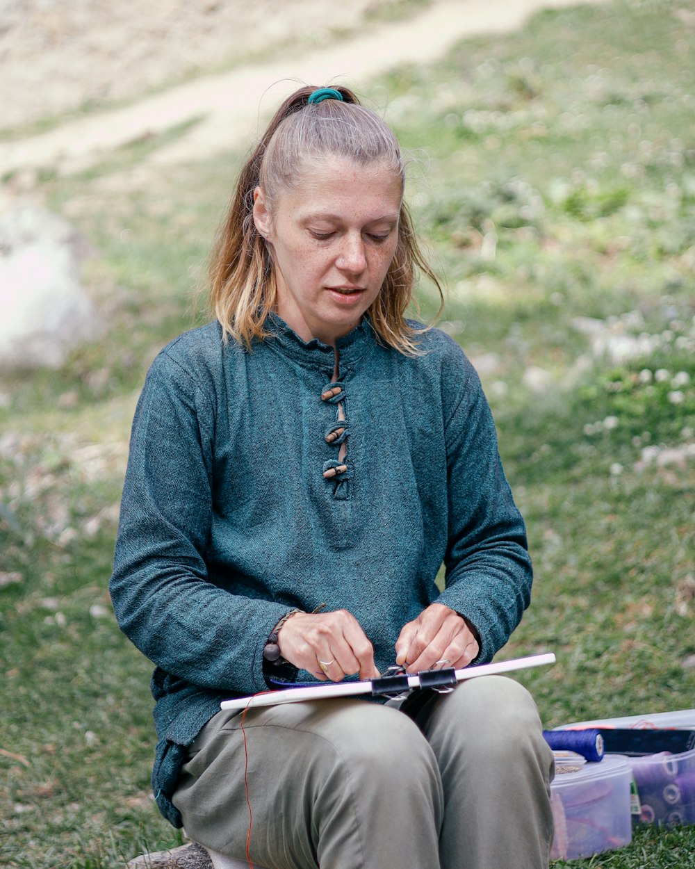 a person sitting outside reading a book