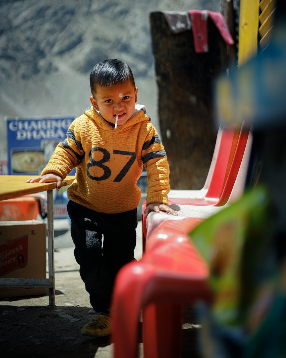 a boy holding a red bucket