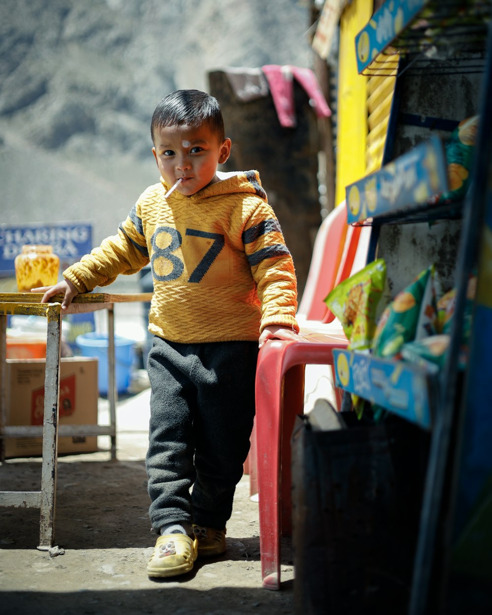 a boy standing in front of a store