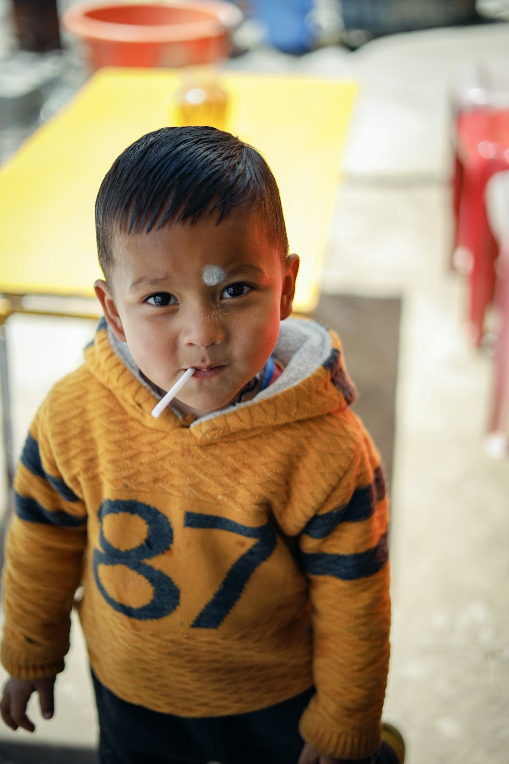 a child with a cigarette in his mouth