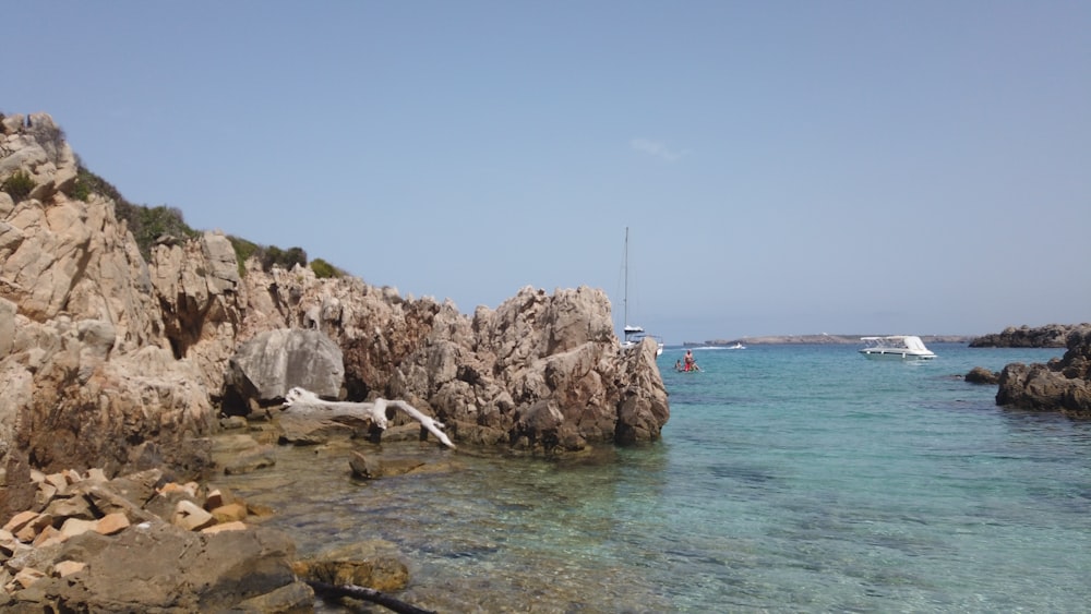 a rocky beach with a boat