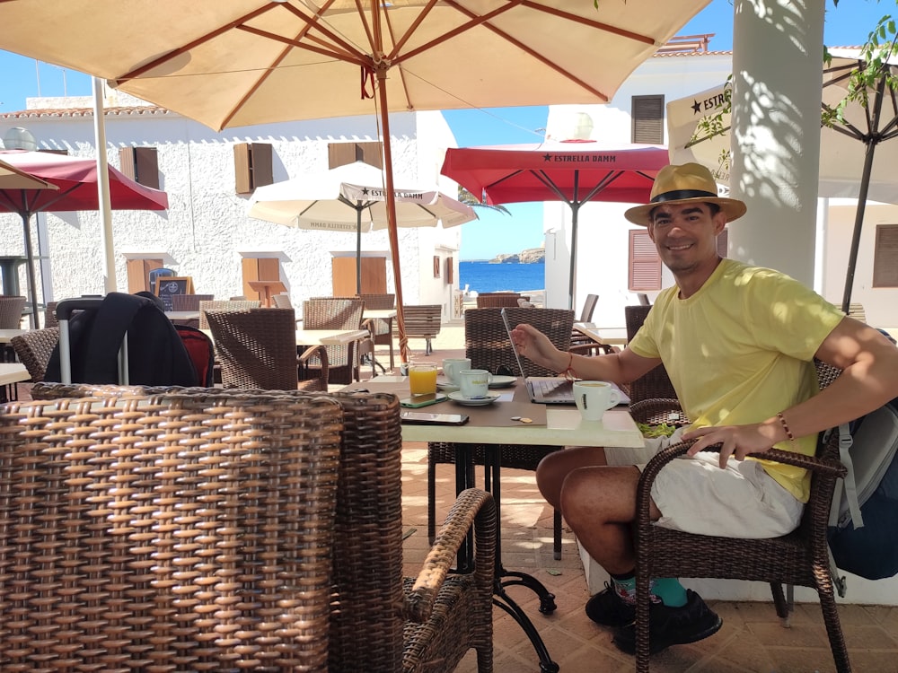 a person sitting at a table with a laptop