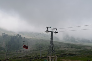 a group of people on a cable car above a valley