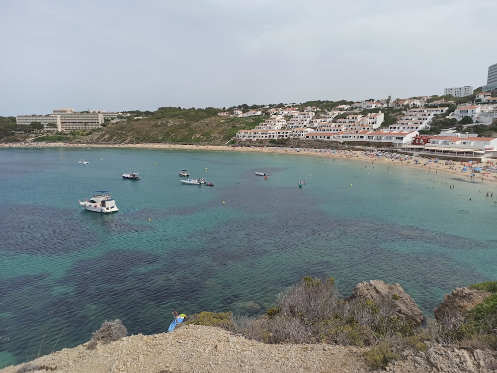 a body of water with boats in it and buildings in the back